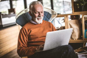 older man using laptop